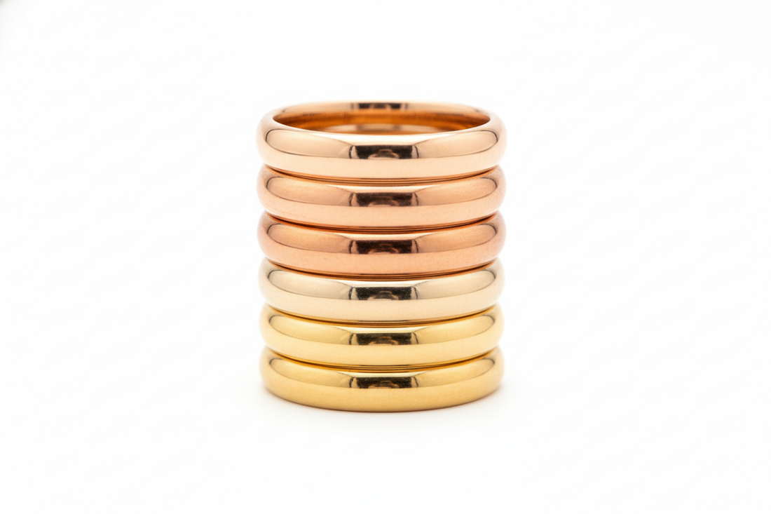 a stack of gold bands of different karats so that you can compare the different colours of the different karats