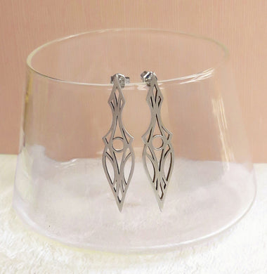 Art deco dagger stud earrings. Made of brushed sterling silver and oxidized for contrast. Hanging on a glass.