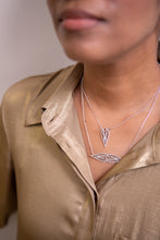 Load image into Gallery viewer, Model in a gold top wearing a sterling silver art deco symmetrical teardrop necklace and matching teardrop pendant necklace.
