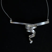 Load image into Gallery viewer, A modern sterling silver helix spiral ribbon pendant necklace on a black background.
