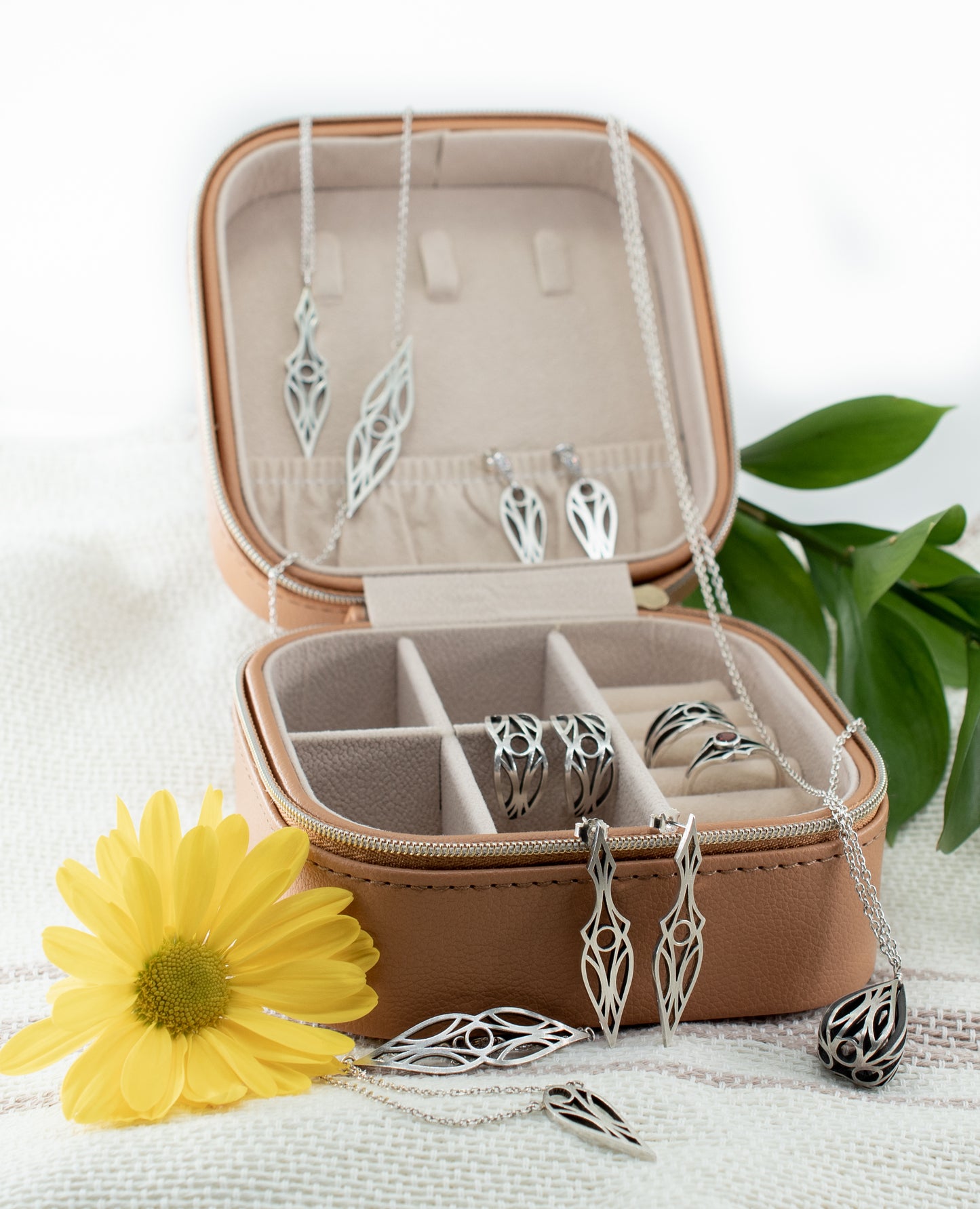 A collection of sterling silver art deco teardrop and dagger jewellery in a jewellery case. Pendants, necklaces, earrings, and bracelets.