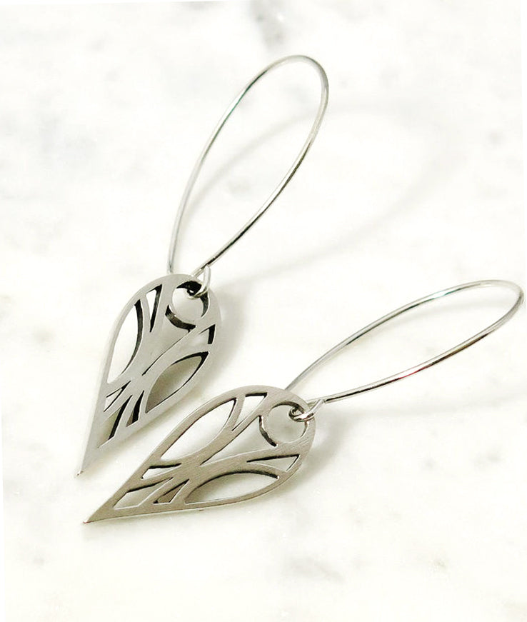 Art deco geometric teardrop hoop earrings of sterling silver with a high-sheen brushed finish and oxidized for contrast on a white background.